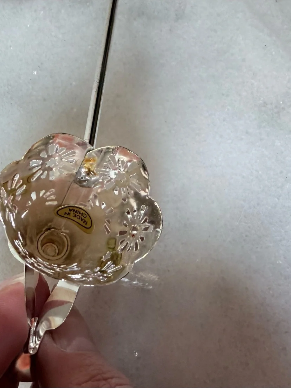 silver-tone angel candle snuffer features intricate, cutout wing and robe